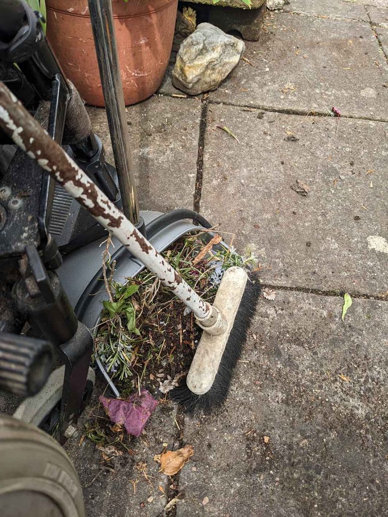 Upright dustpan and brush.