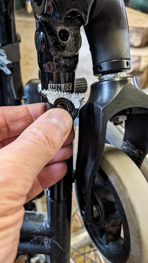 Part that has sheared off the clamp for wheelchair castor.